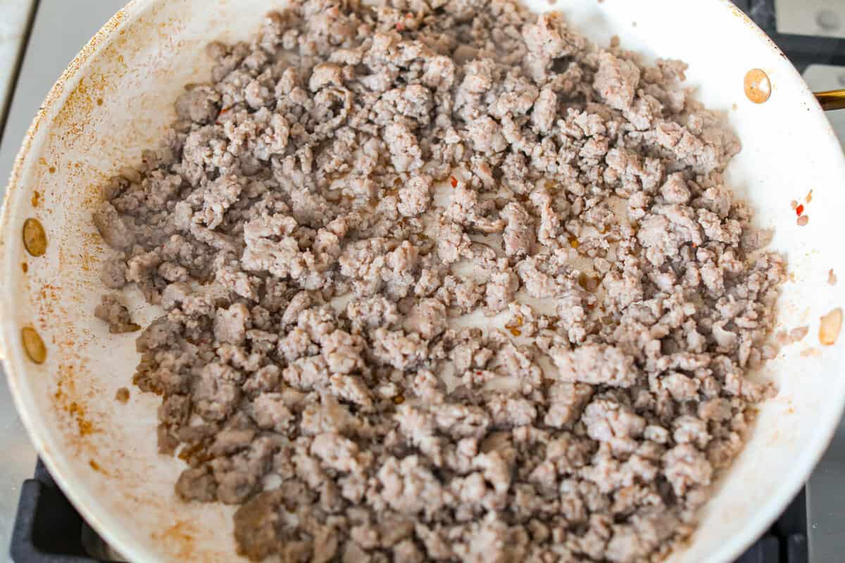 Sausage cooking in a skillet.