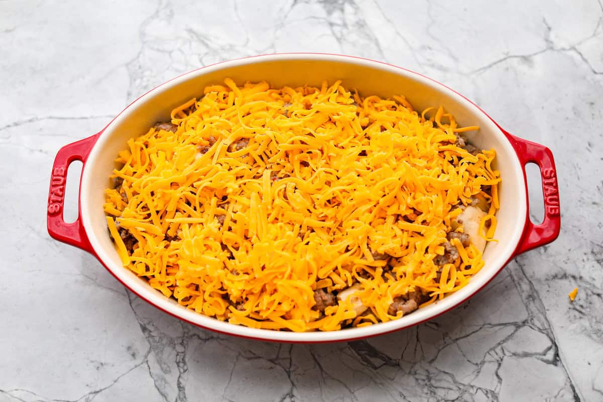 Cheese sprinkled over the top of the sausage and biscuits.