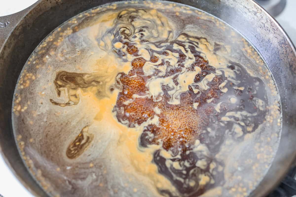 Sauce mixture added to the pan to reduce and thicken.