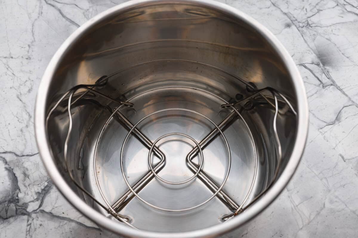 Instant pot with trivet and water added to it.