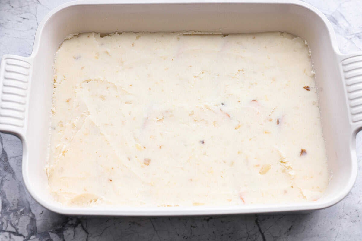 Mashed potatoes layered over the top of the turkey.