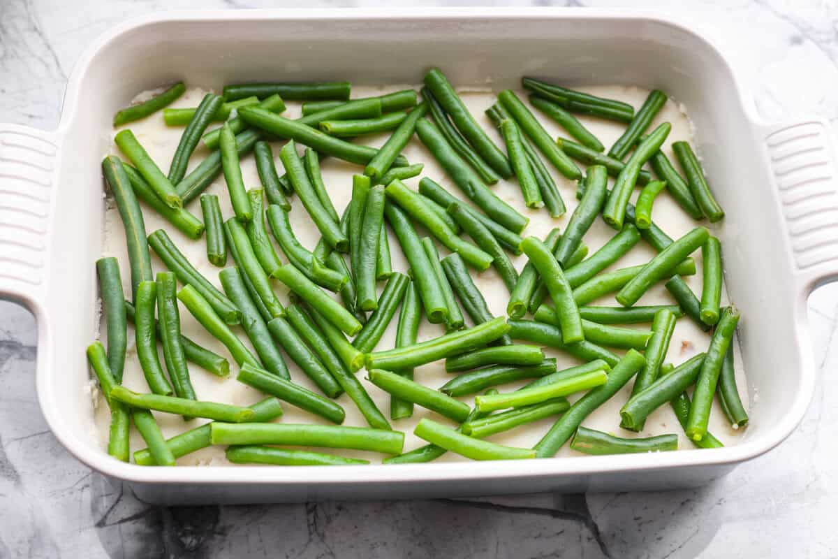 Green beans sprinkled on top of the mashed potatoes.