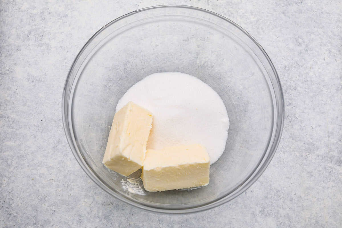 Sugar and butter in a mixing bowl. 