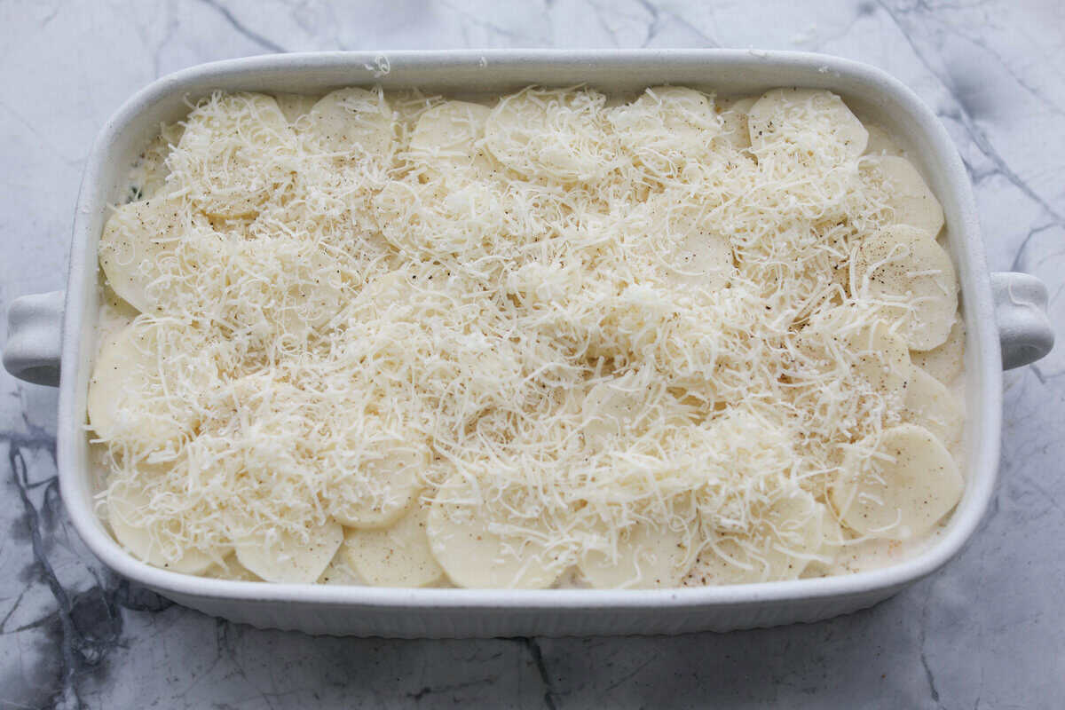 A layer of potatoes and cheese added to the top of the sauce mixture.